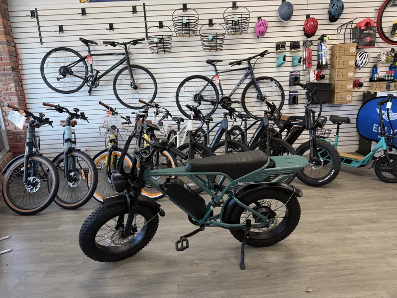 Venom Green Jasion RetroVolt Pro moped-style e-bike on the floor at Lake Park Bicycles in North Palm Beach