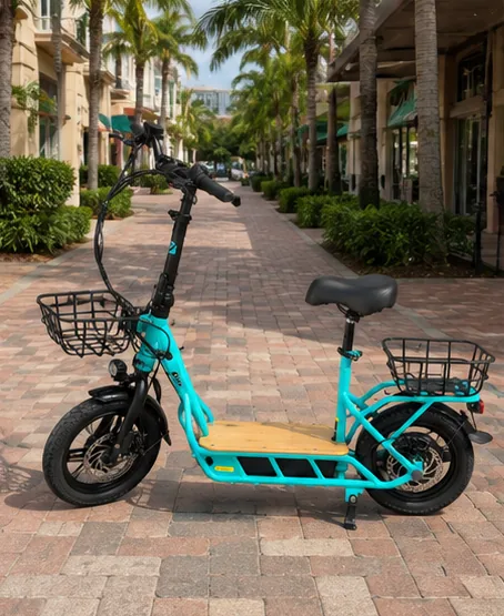 Electric scooter parked on a shop-lined brick sidewalk